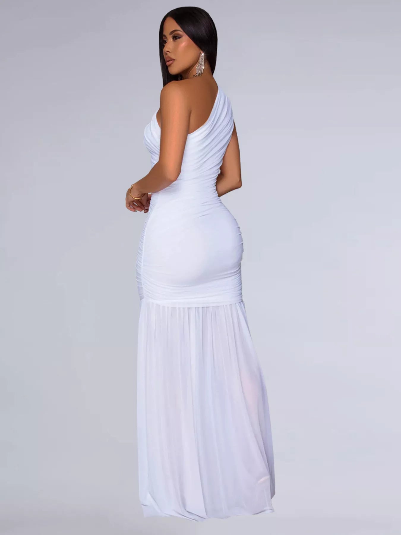 Side view of white one shoulder ruched bodycon maxi dress with flowing skirt