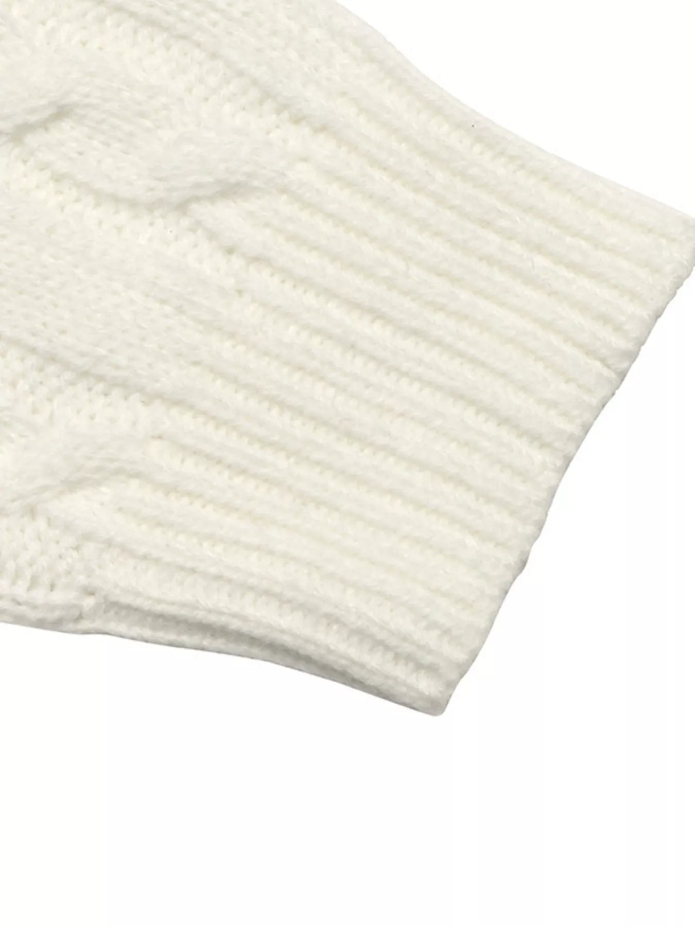 Close up of ribbed cuff on white cable knit long sleeve sweater