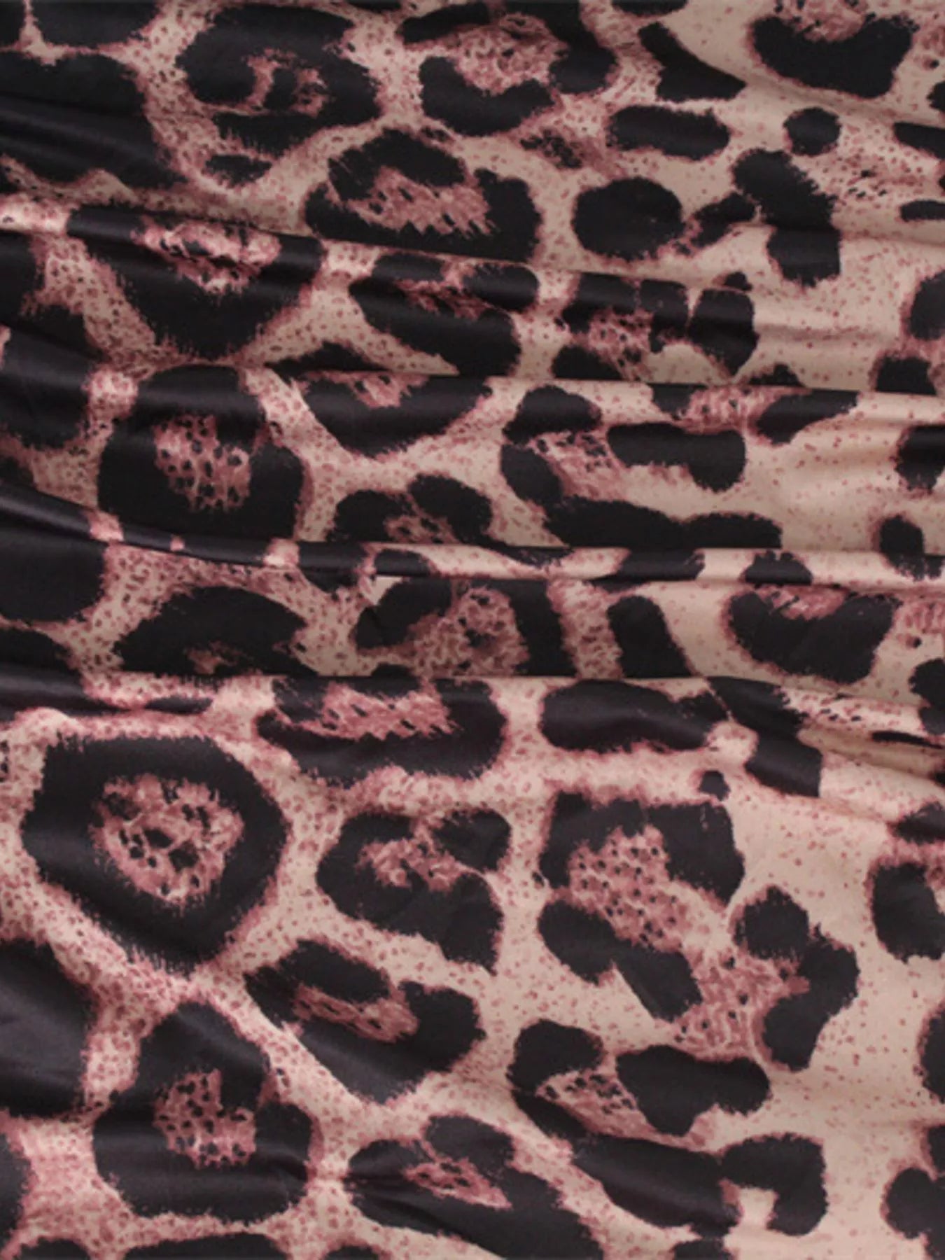 Close up detail of the ruched leopard print fabric on the bodycon midi dress