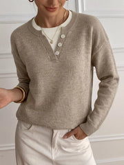 Khaki dropped shoulder sweater with V neck button placket over white ribbed top, front