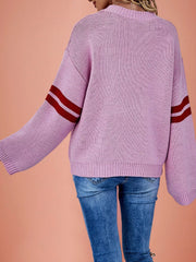 Back view of a pink dropped shoulder sweater with red striped sleeves