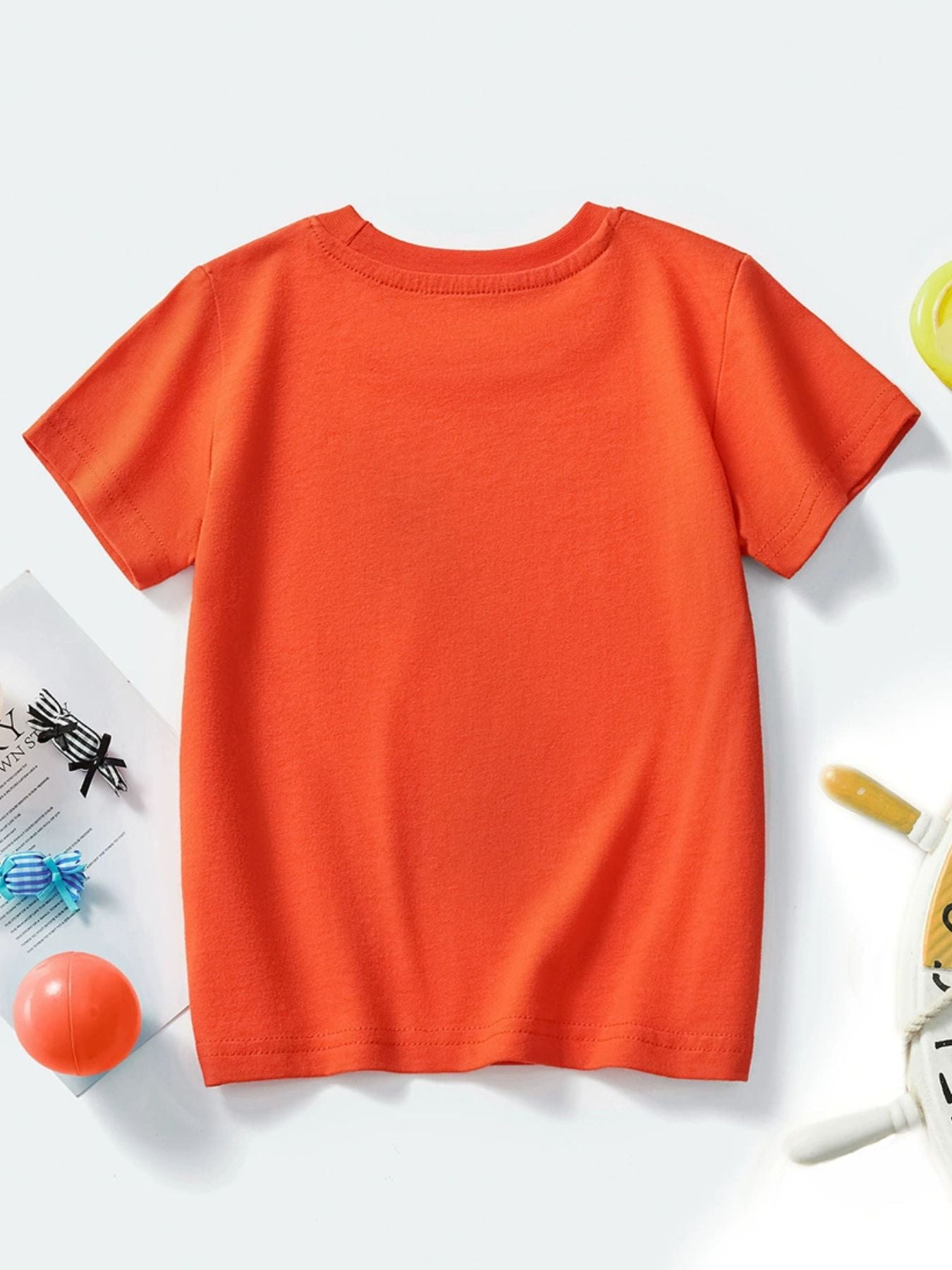 Plain back view of an orange-red children's crew neck short sleeve T-shirt, laid flat