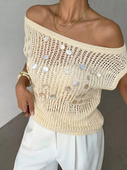 Close up of the cream open knit cover up worn off the shoulder with a ribbed hem
