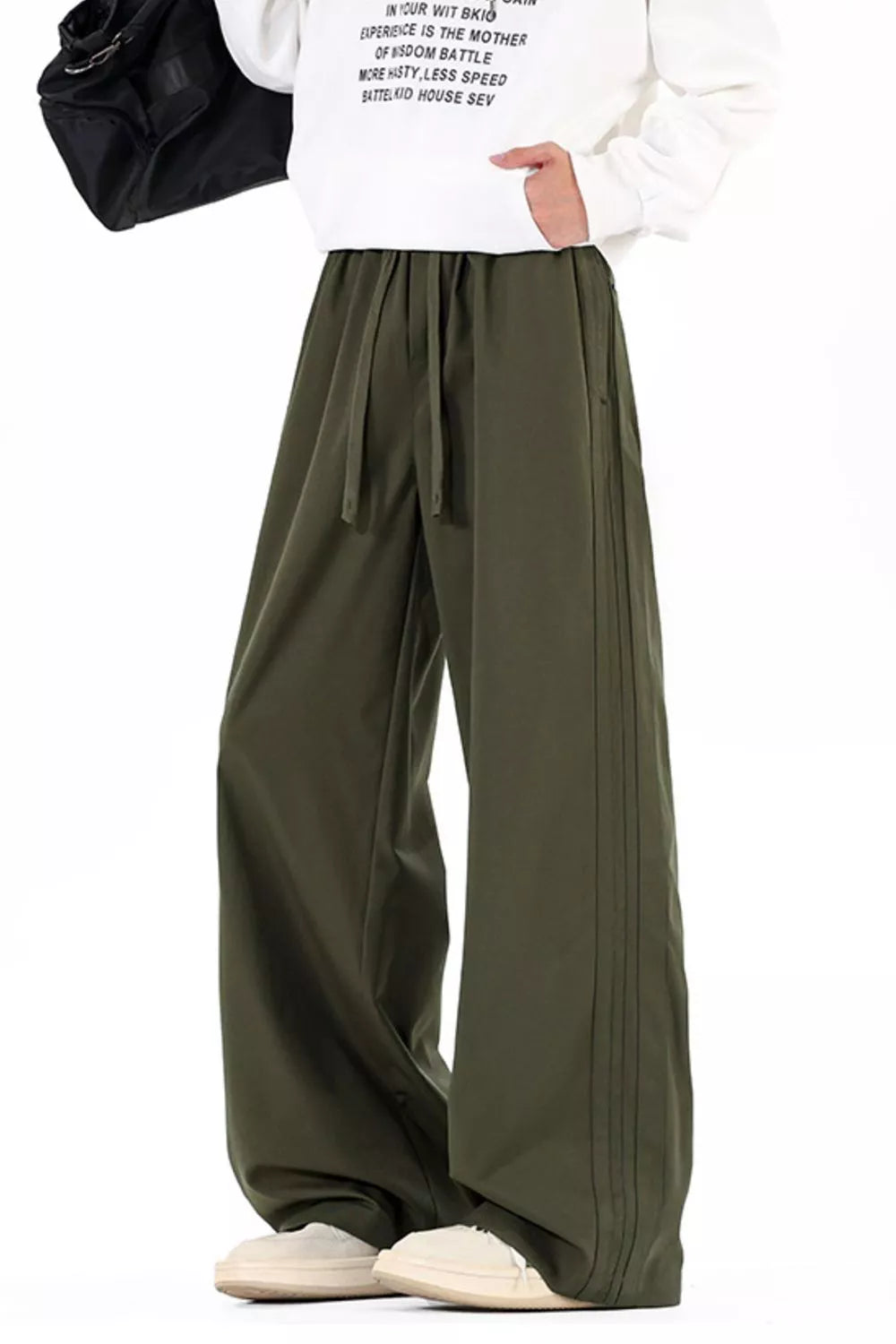 Men's wide leg casual pants with a drawstring waist and pockets.
