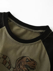 Close-up of the black crew neckline and army green raglan sleeve on the children's shirt