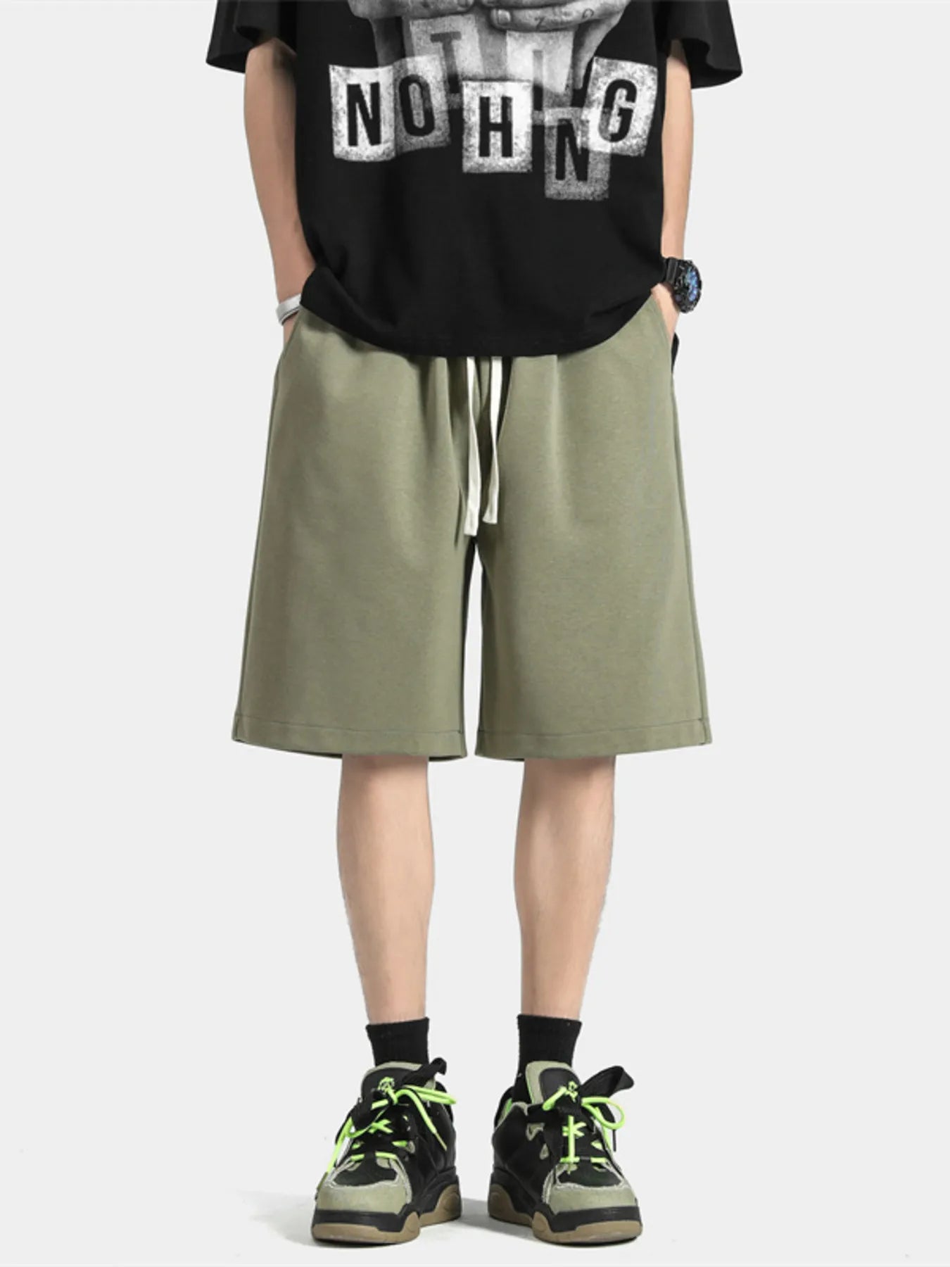 Men's dark green loose-fit casual shorts with a drawstring waist.