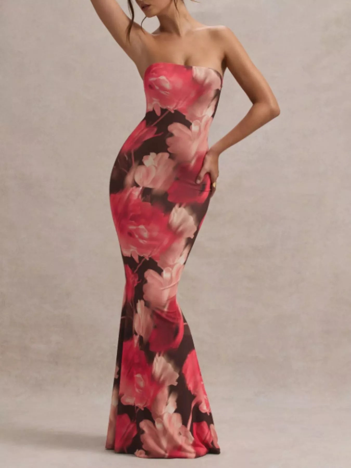 Model wearing strapless dark brown and red floral tube maxi dress, front view in studio