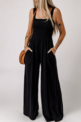 Women's smocked square-neck jumpsuit with sleeveless styling, wide legs, and pockets.