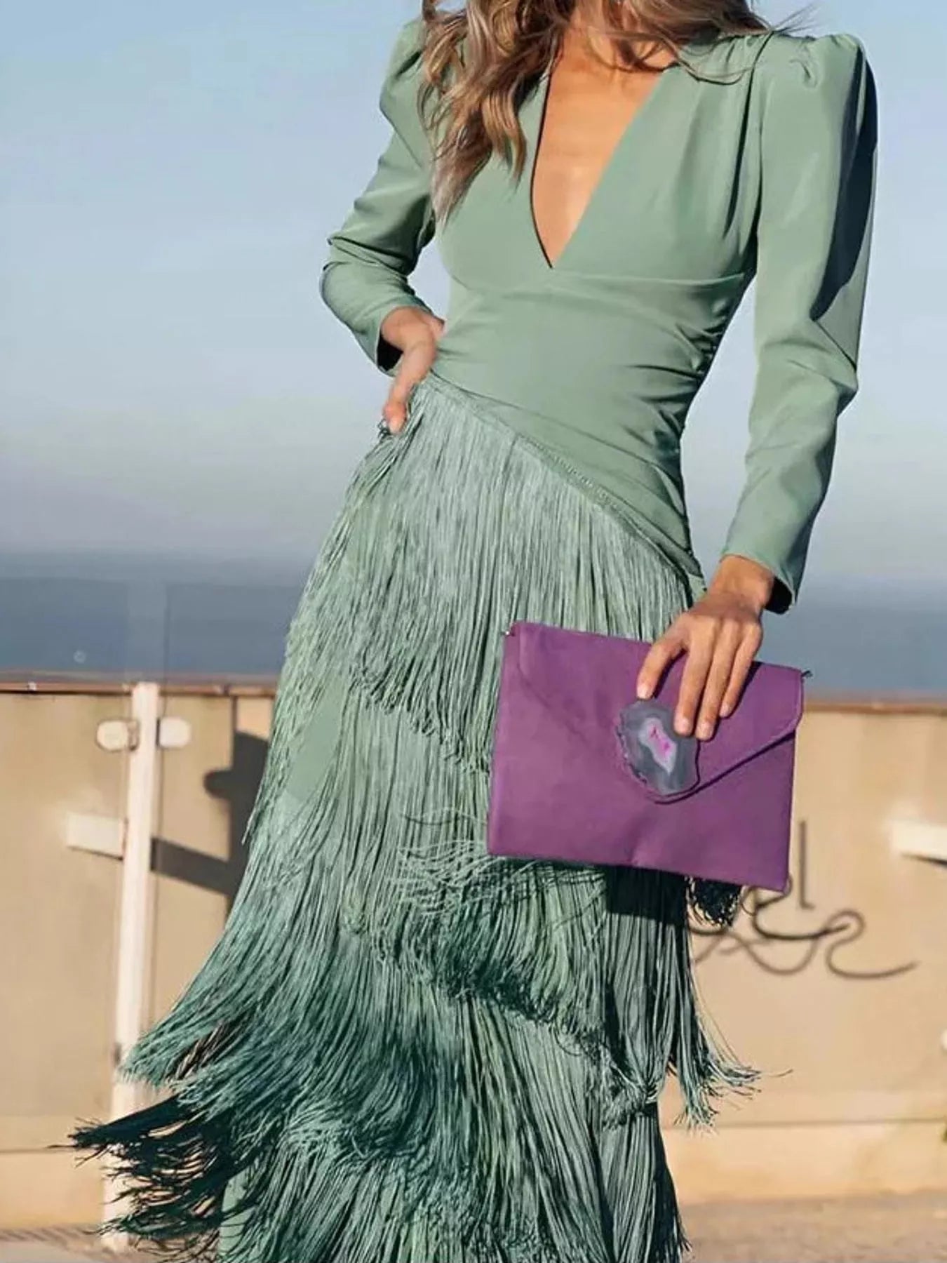 Front view of a gum leaf green fringed maxi dress with a flowing tiered skirt