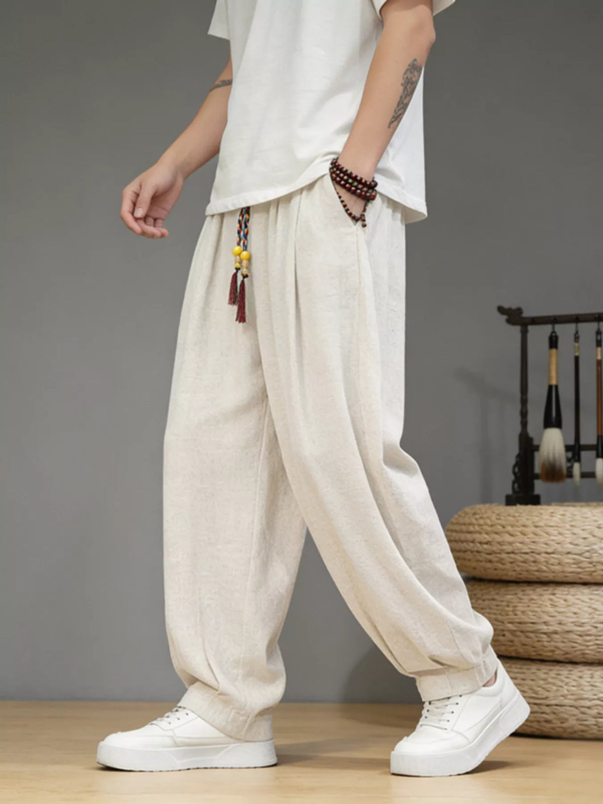 Men's loose fit casual pants with a drawstring waist and pockets.