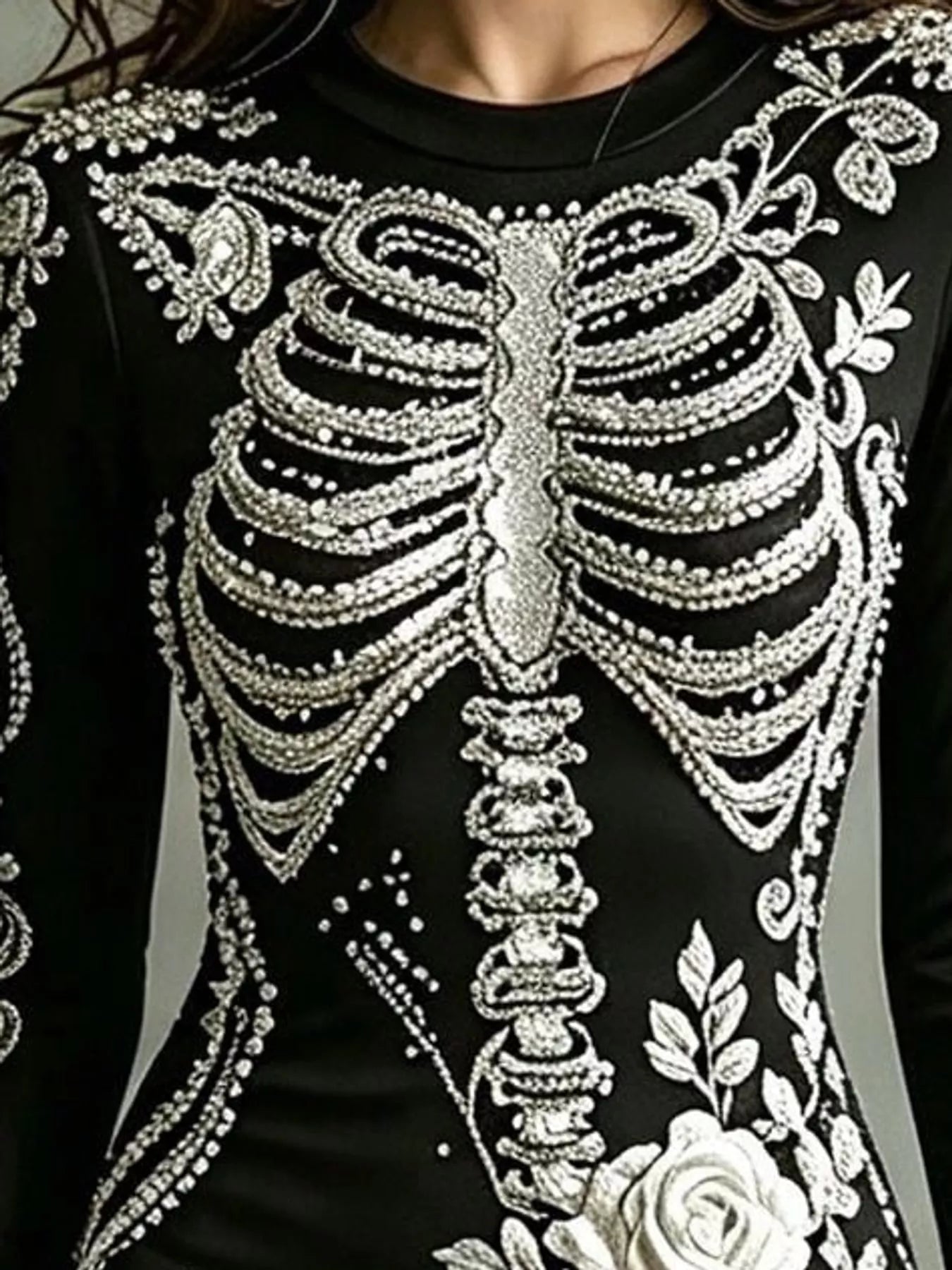 Close detail of white skeleton print on black long sleeve bodycon dress bodice