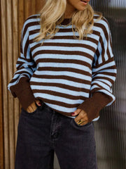 On-model front view of a brown and light blue striped crew neck sweater