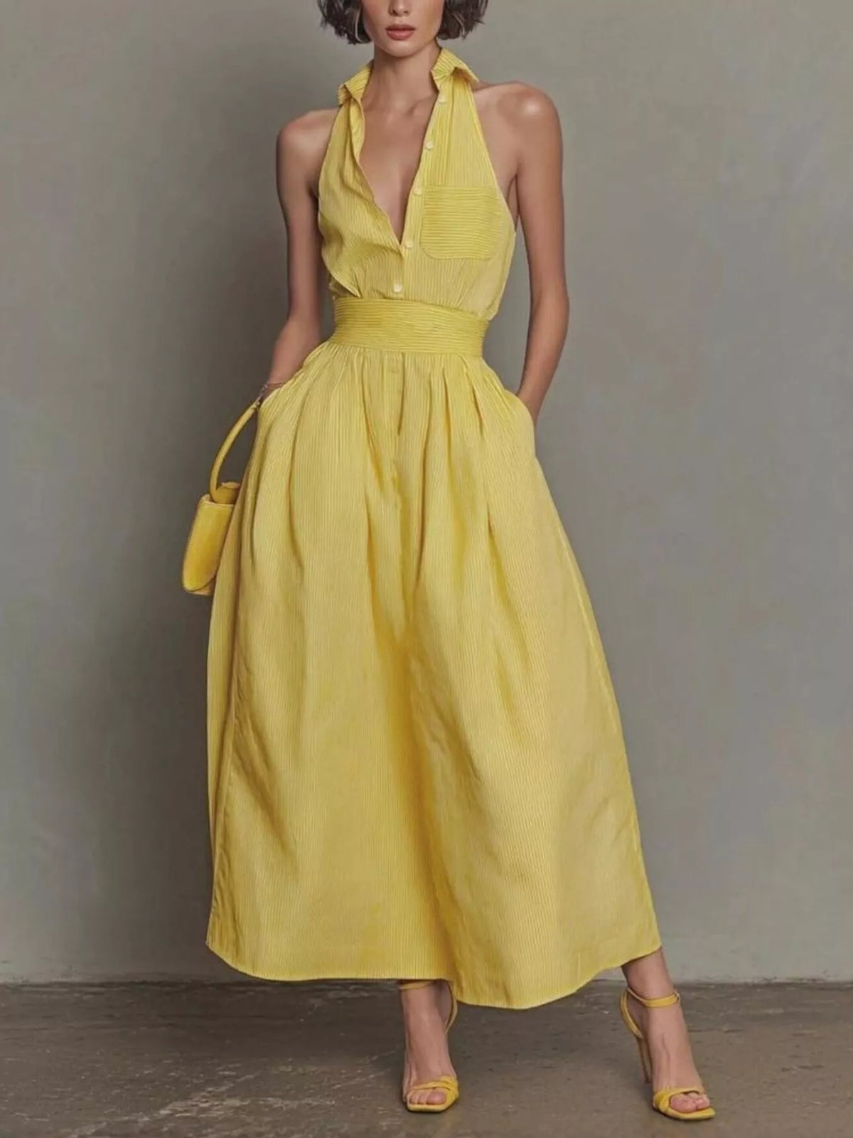 Full front view of yellow sleeveless maxi dress with collar buttons and side pockets