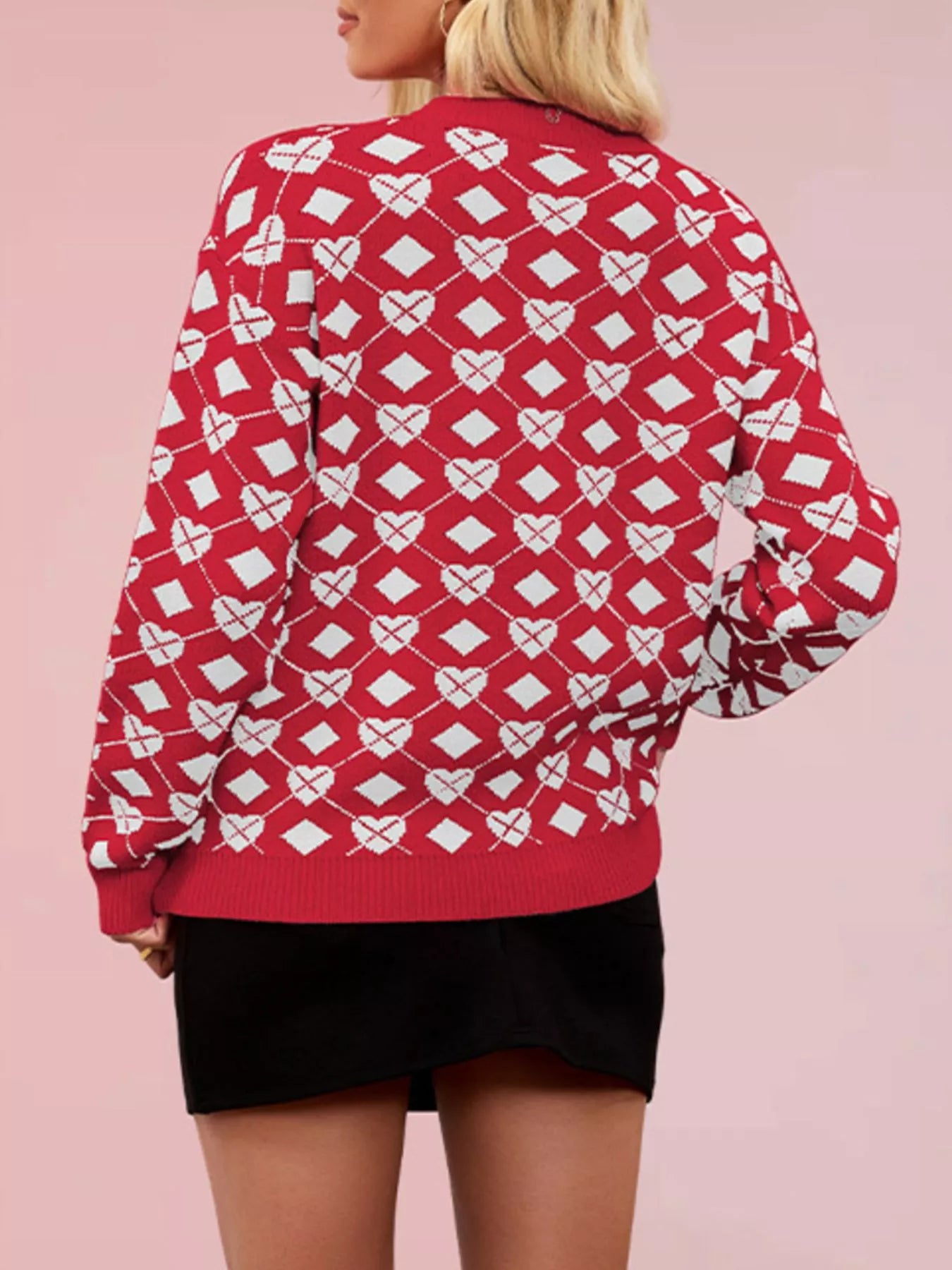 Back view of a red knit sweater with white heart and diamond argyle pattern