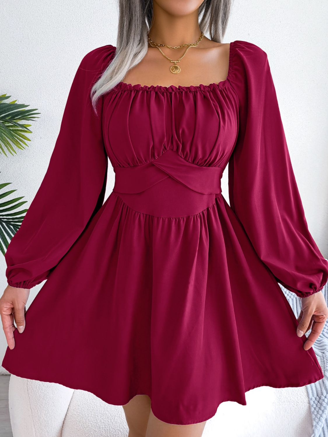 Women's mini dress with a square neckline, long balloon sleeves and tie detail.