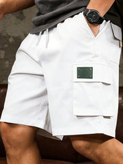 Men's white cargo shorts with a drawstring waist and pockets.