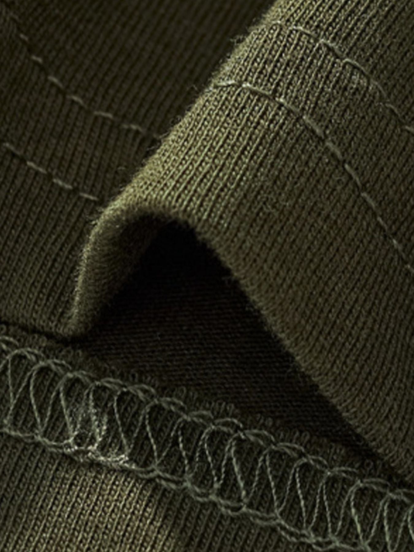 Close-up of the army green sleeve hem and stitching detail on a children's T-shirt