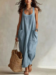 Model wearing light blue sleeveless scoop neck maxi dress, full view with large front pockets