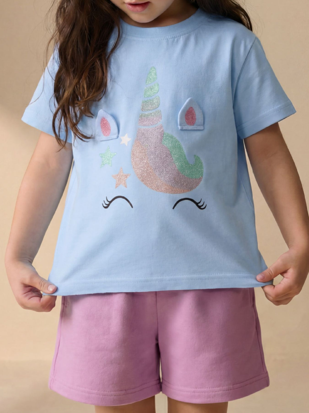 Children's sky blue t-shirt worn in front view with glitter unicorn face and stars