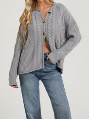 Front view of gray cable knit button down cardigan with brown buttons and blue jeans