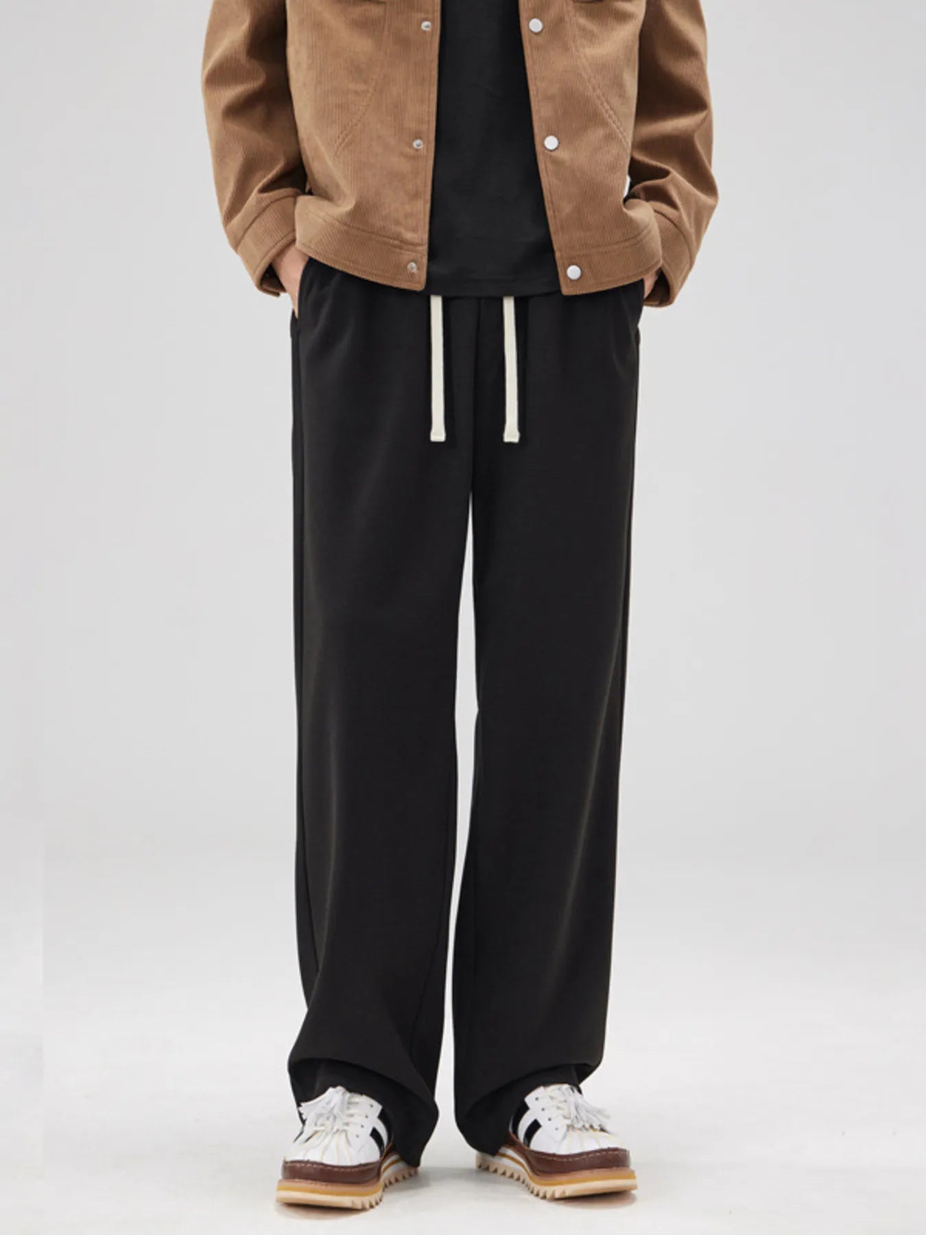 Men's black pants with a relaxed fit and drawstring waist.