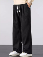 Men's black lightweight loose-fit pants with a drawstring waist and pockets.