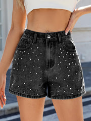 Women's washed high-waist denim shorts with rhinestone details and pockets.