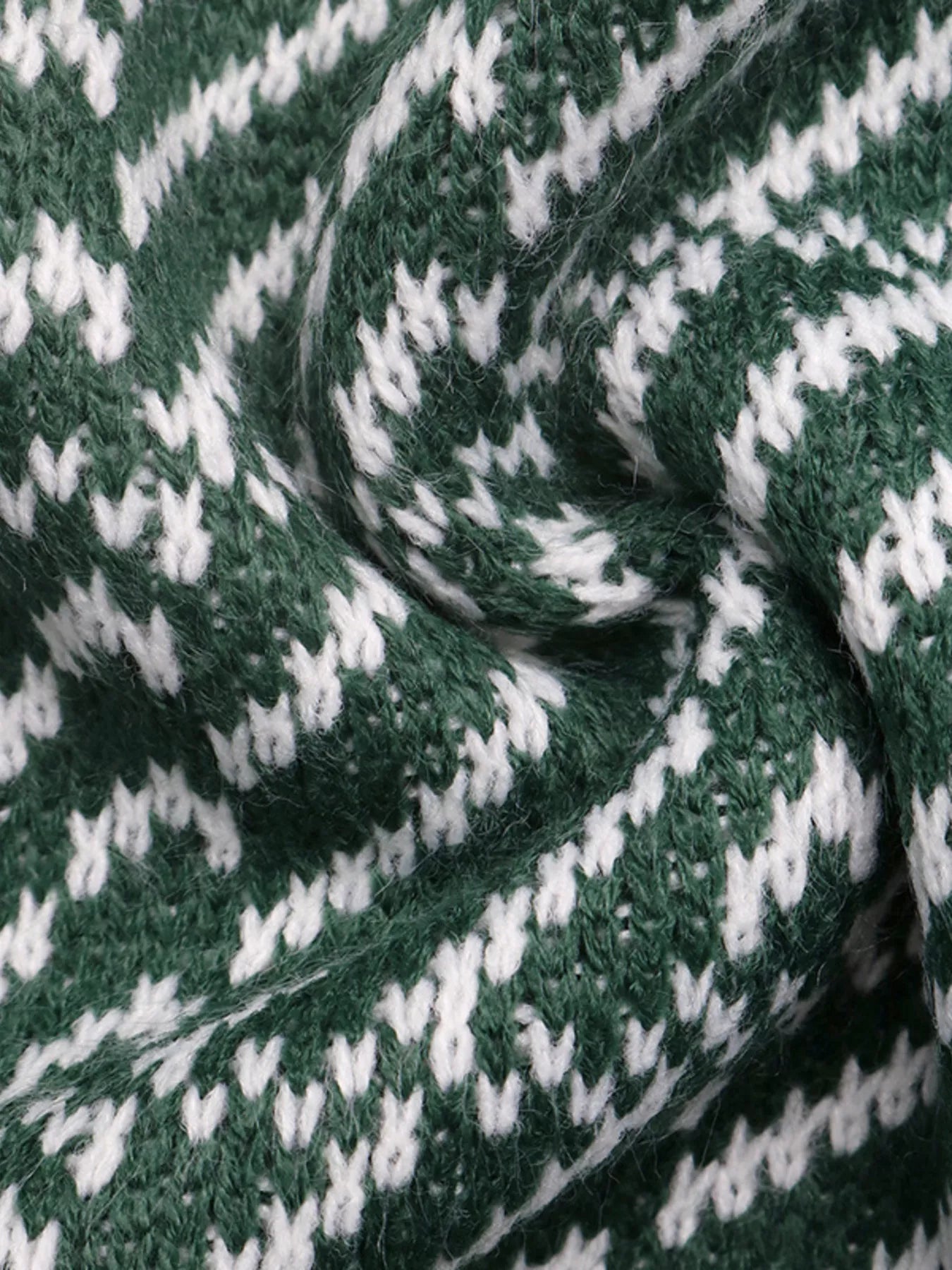 Close-up of the green and white geometric knit fabric texture