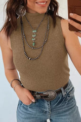 Mirror selfie view of a mocha ribbed mock neck sweater vest with jeans