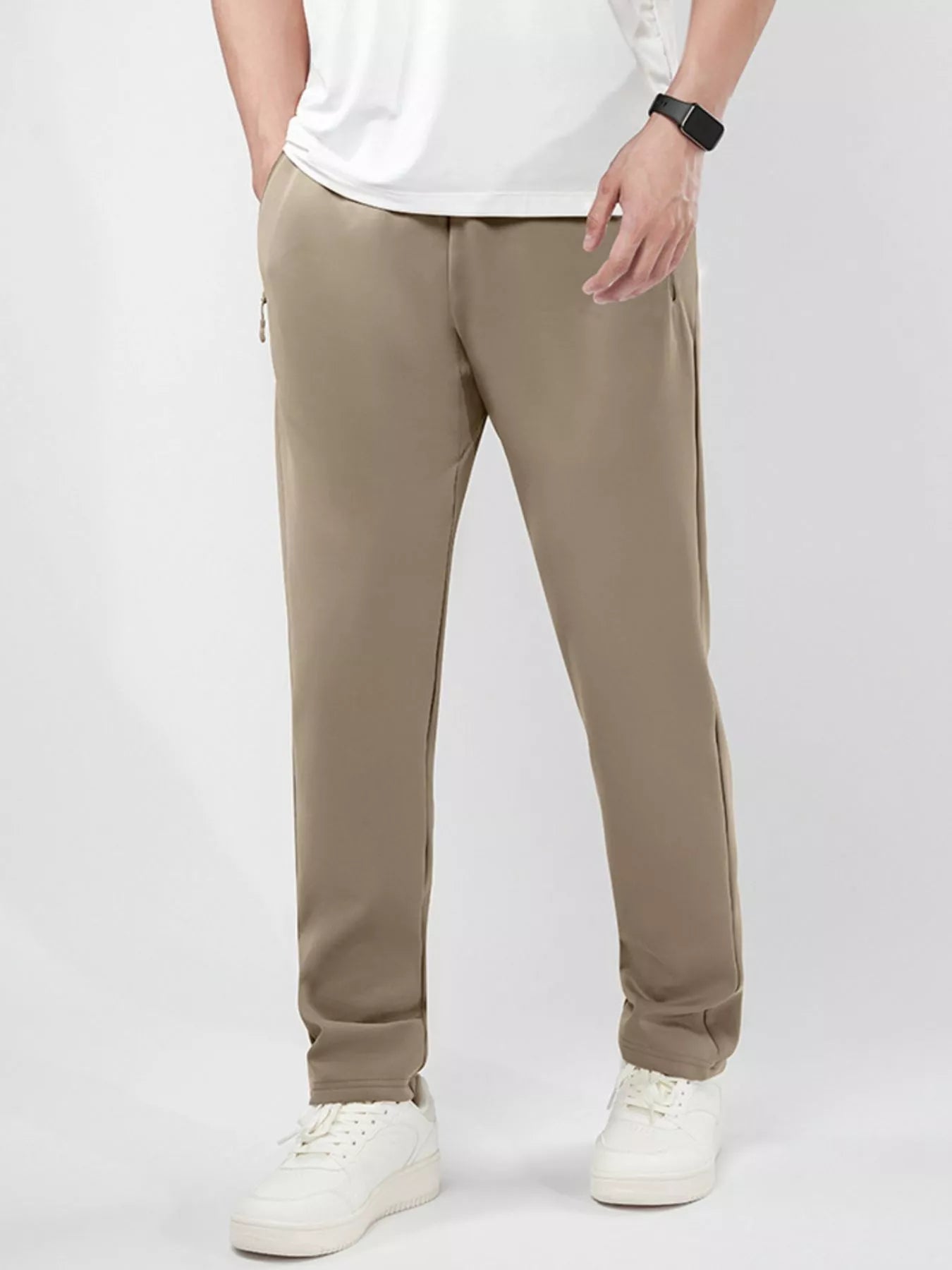 Men's plus-size stretch pants in camel with an elastic waist and zipper pockets.