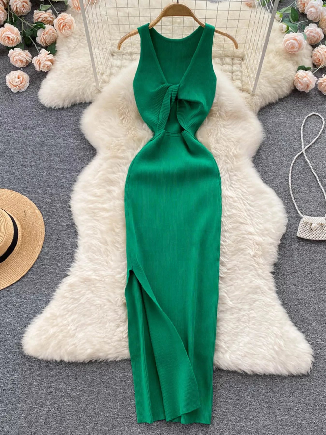 Emerald green sleeveless knit bodycon midi dress, full back view with side slit