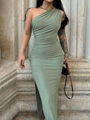 Model wearing green one shoulder ruched bodycon slit dress, front view outdoors