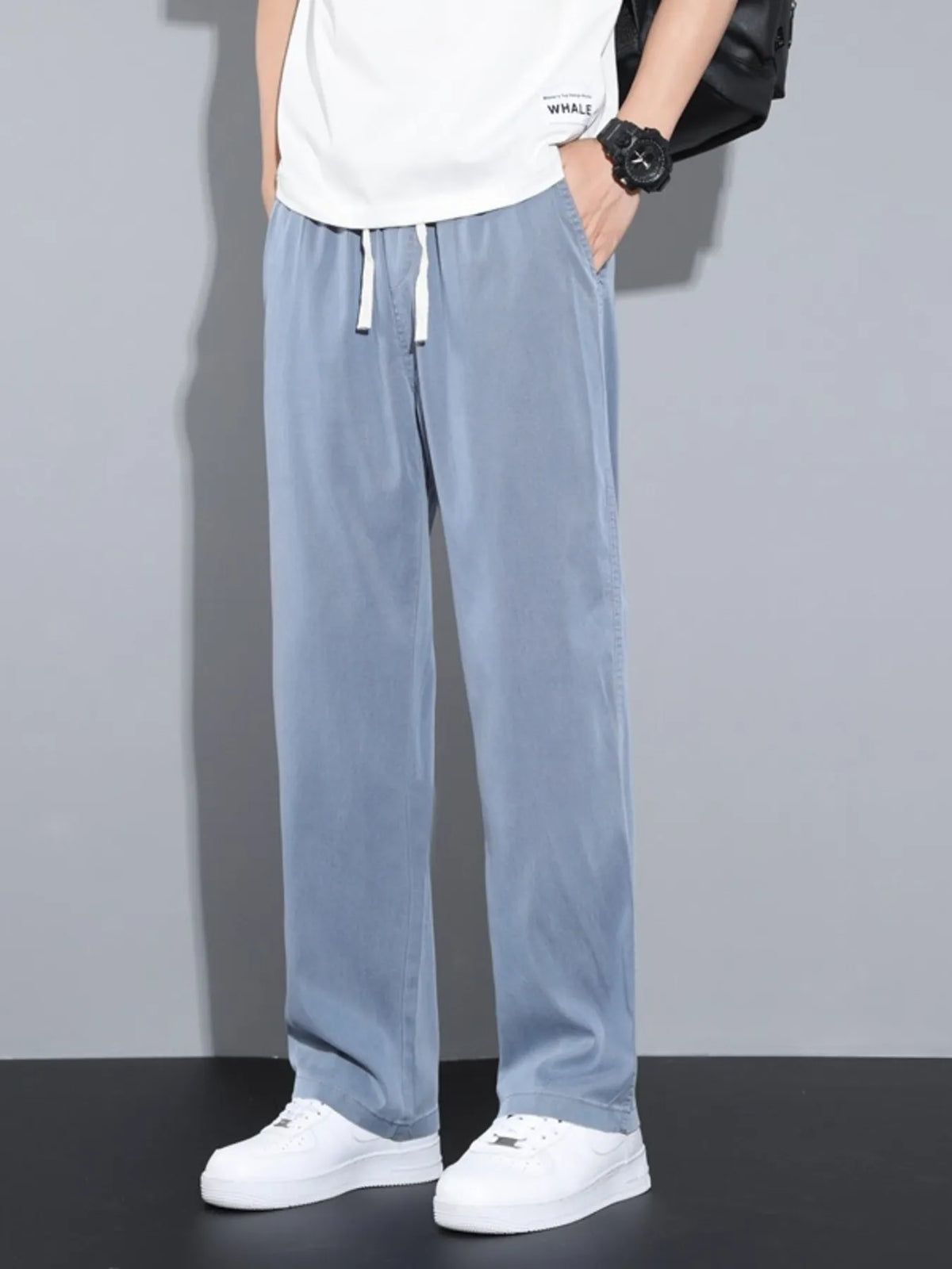 Men's blue casual pants with wide legs and a drawstring waist.