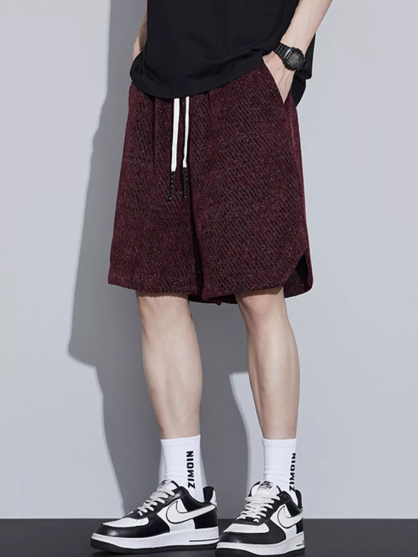Men's loose fit shorts with a drawstring waist and pockets.