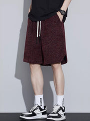 Men's loose fit shorts with a drawstring waist and pockets.