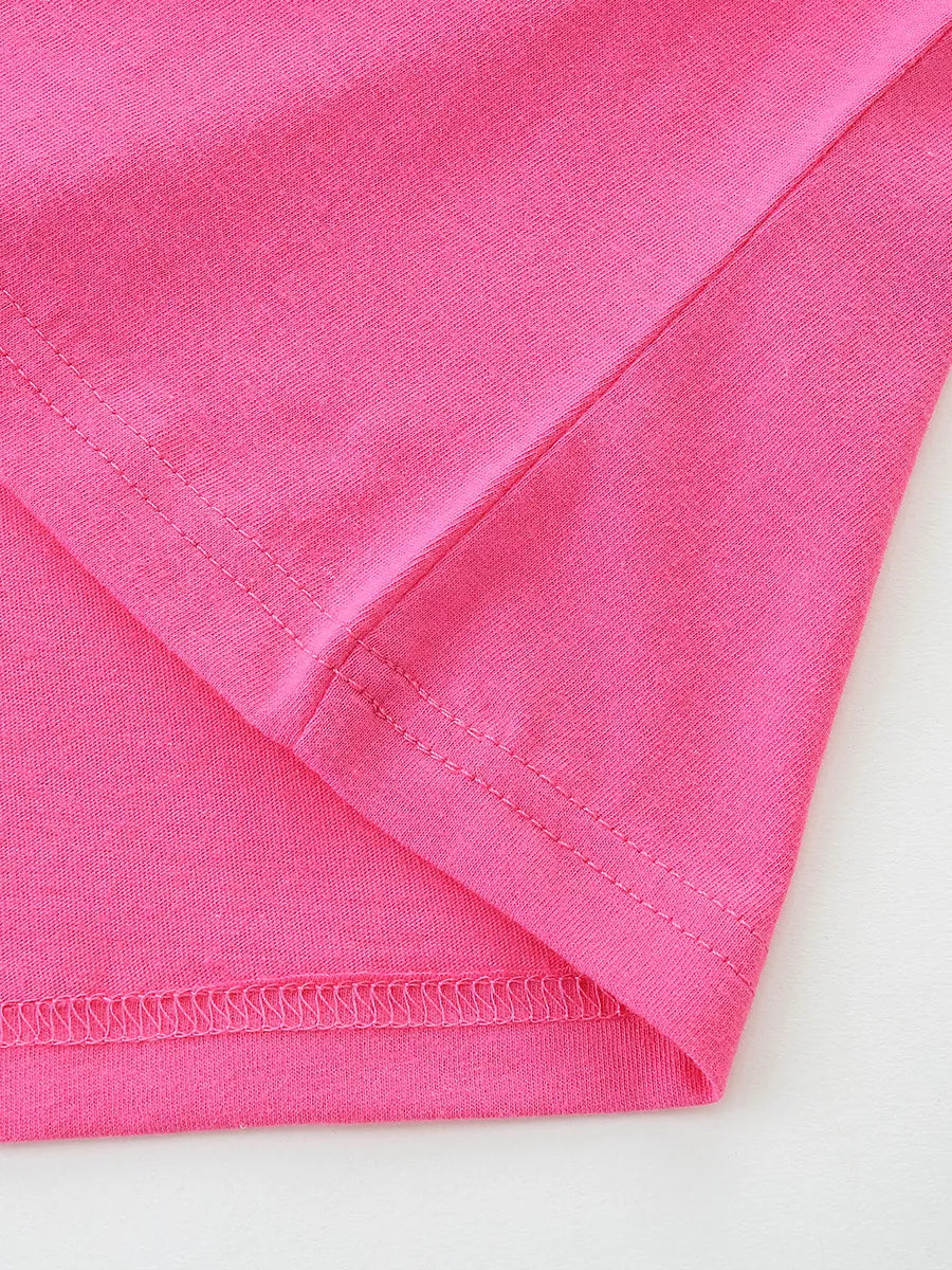 Close view of hem stitching on a hot pink children's short sleeve rainbow tee
