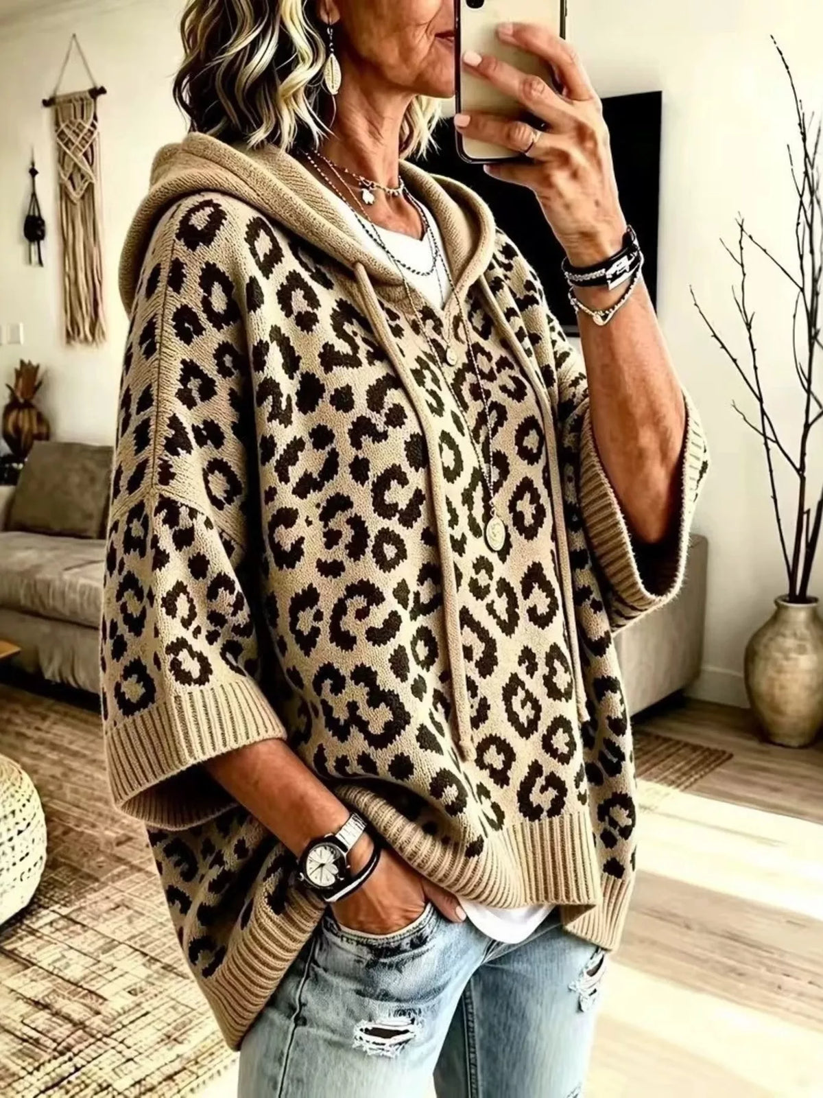 Beige leopard print oversized hooded knit sweater with drawstrings, front angle view on model