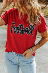 Outdoor front view of deep red game day t shirt with polka dot Football lettering and jeans