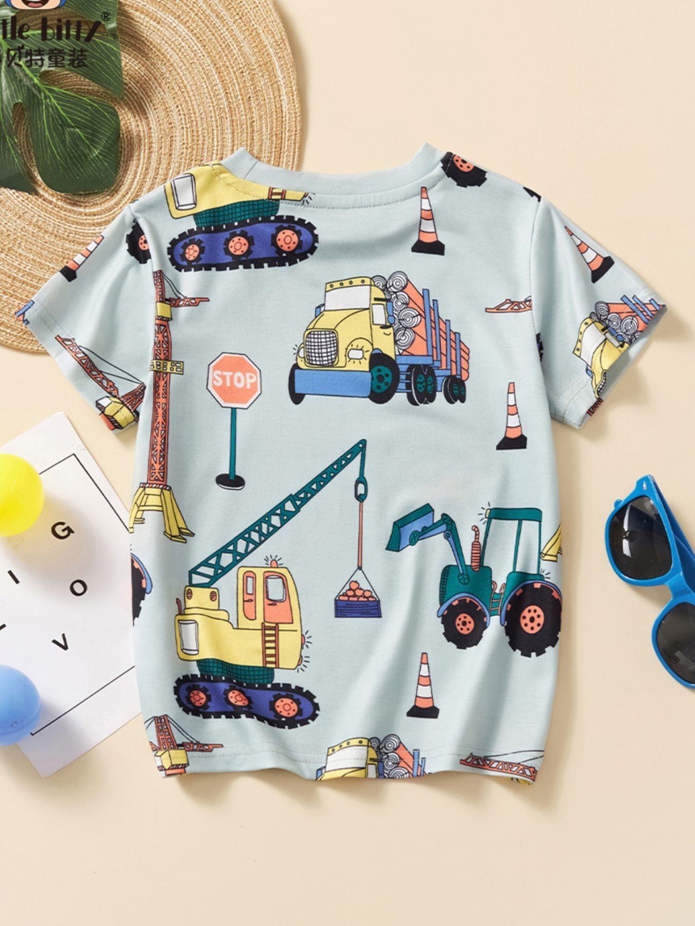 Back view of the light children's tee with an all-over construction vehicle print
