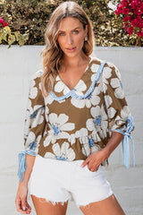 Blusa con mangas anudadas y estampado floral a rayas