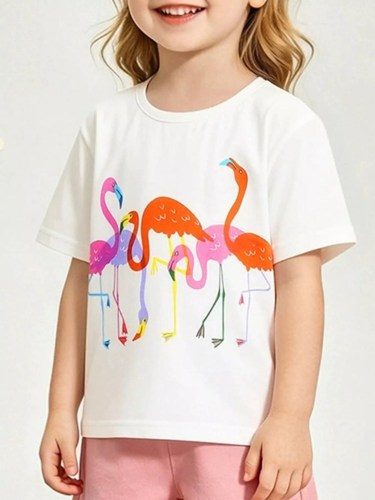 White children's short sleeve t-shirt with colorful pink orange and purple flamingo print