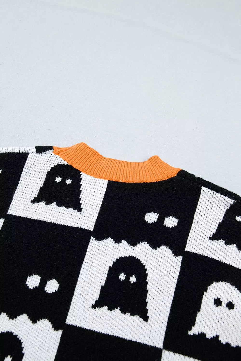 Close up of the back neckline and ghost checkerboard knit of a sweater