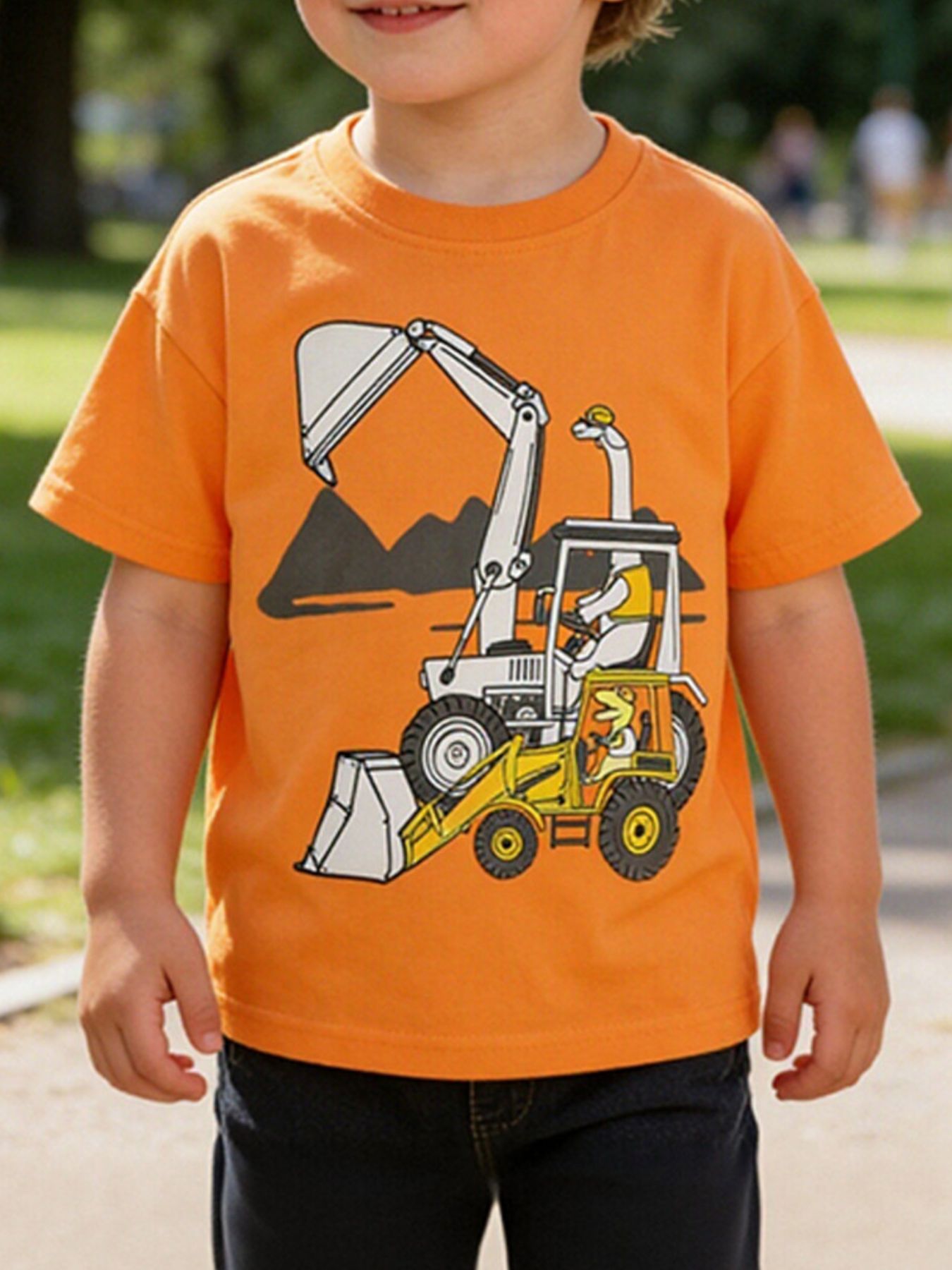 Children's orange short sleeve T-shirt with a cartoon excavator graphic, shown worn in front view