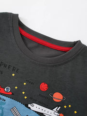 Close-up of the gray round neckline with red inner trim and cartoon planets above a space shuttle