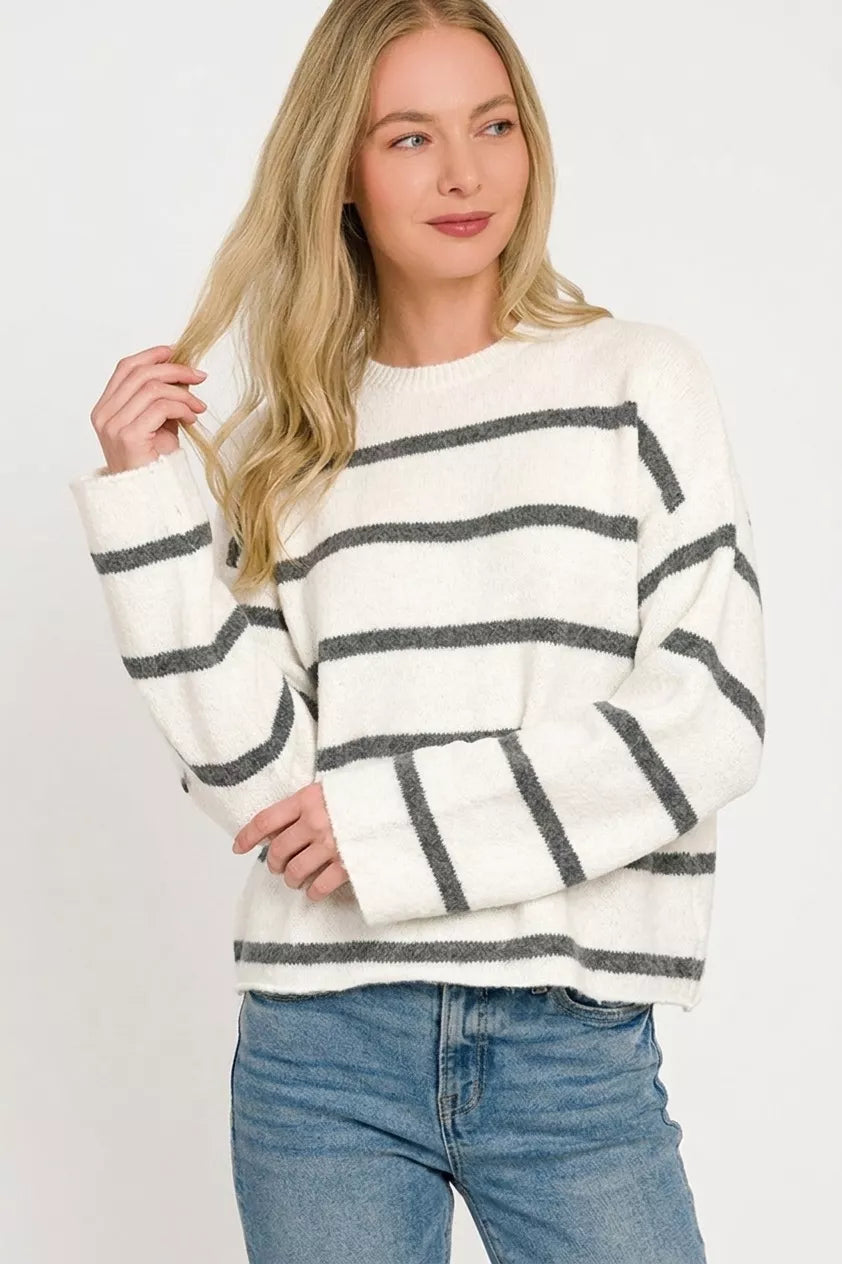 White charcoal striped wool blend sweater shown front on with light wash jeans