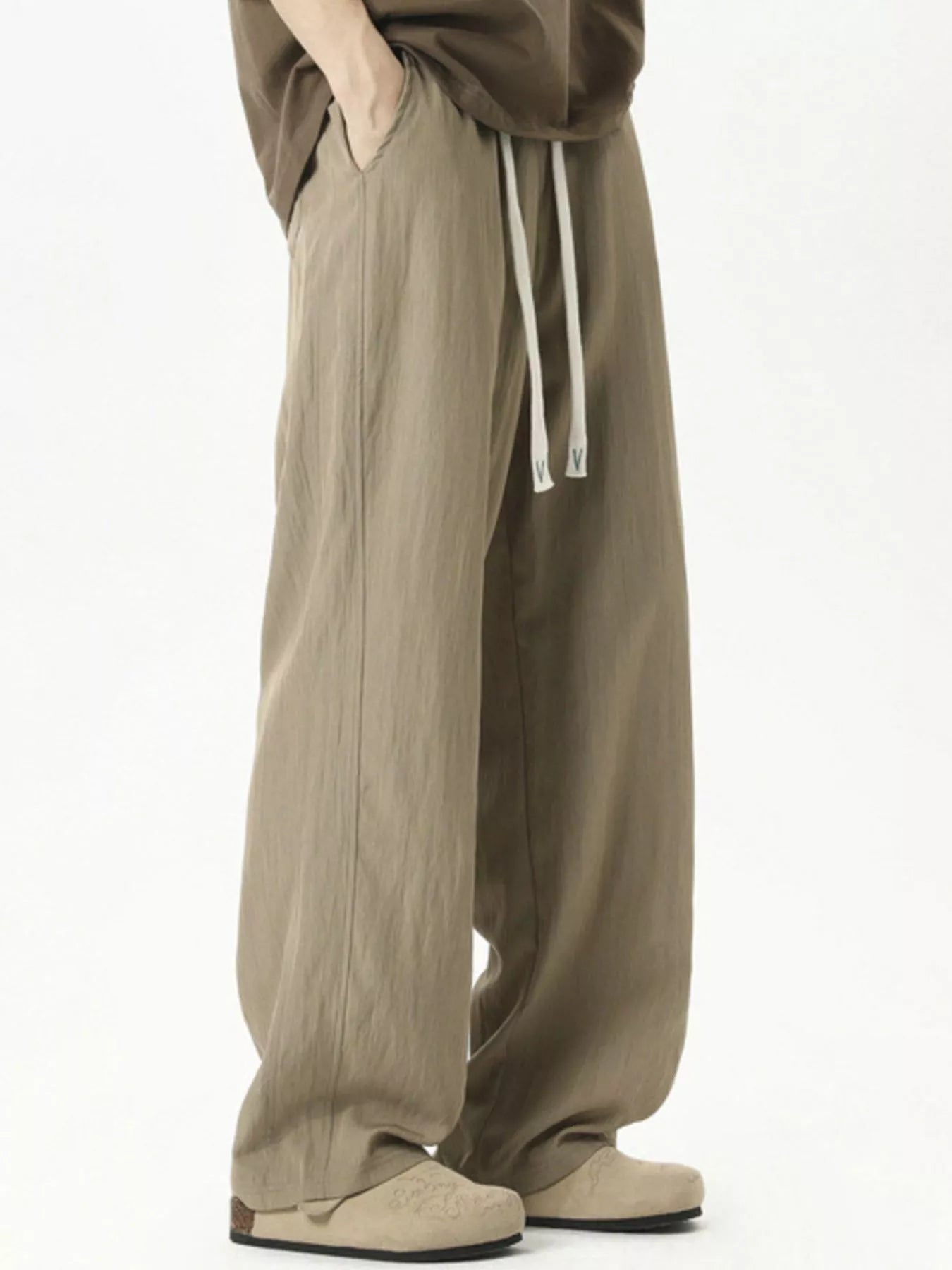 Men's lightweight loose fit casual pants with a drawstring waist.