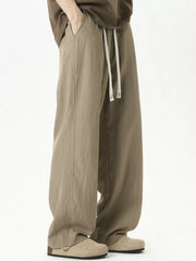 Men's lightweight loose fit casual pants with a drawstring waist.