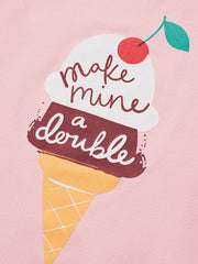 Close-up detail of the ice cream cone graphic with a cherry and script lettering on pink fabric