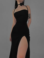 Black halter neck bodycon dress with a high thigh slit worn front facing