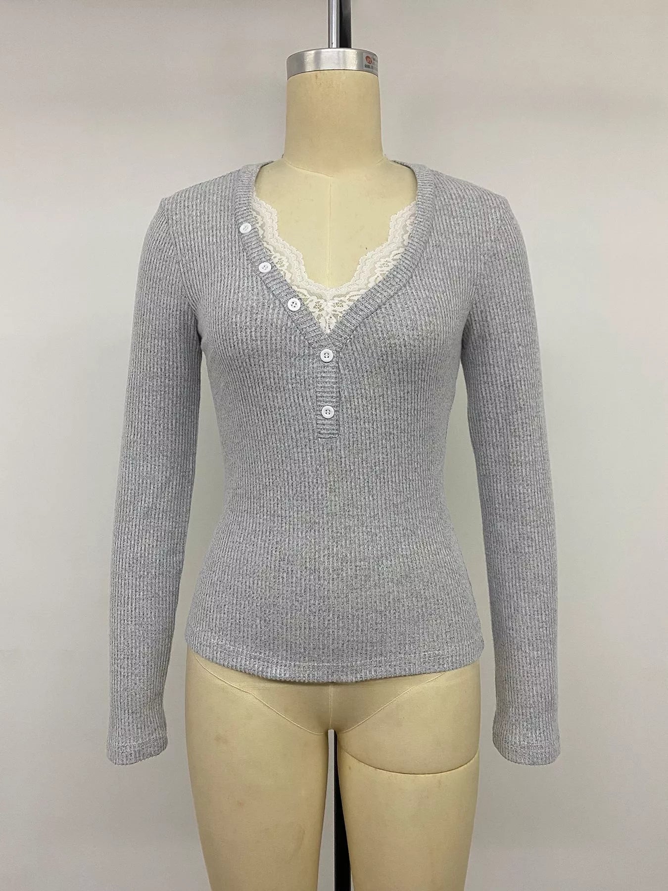 Gray ribbed long-sleeve Henley top with lace-trimmed neckline and button placket on mannequin.